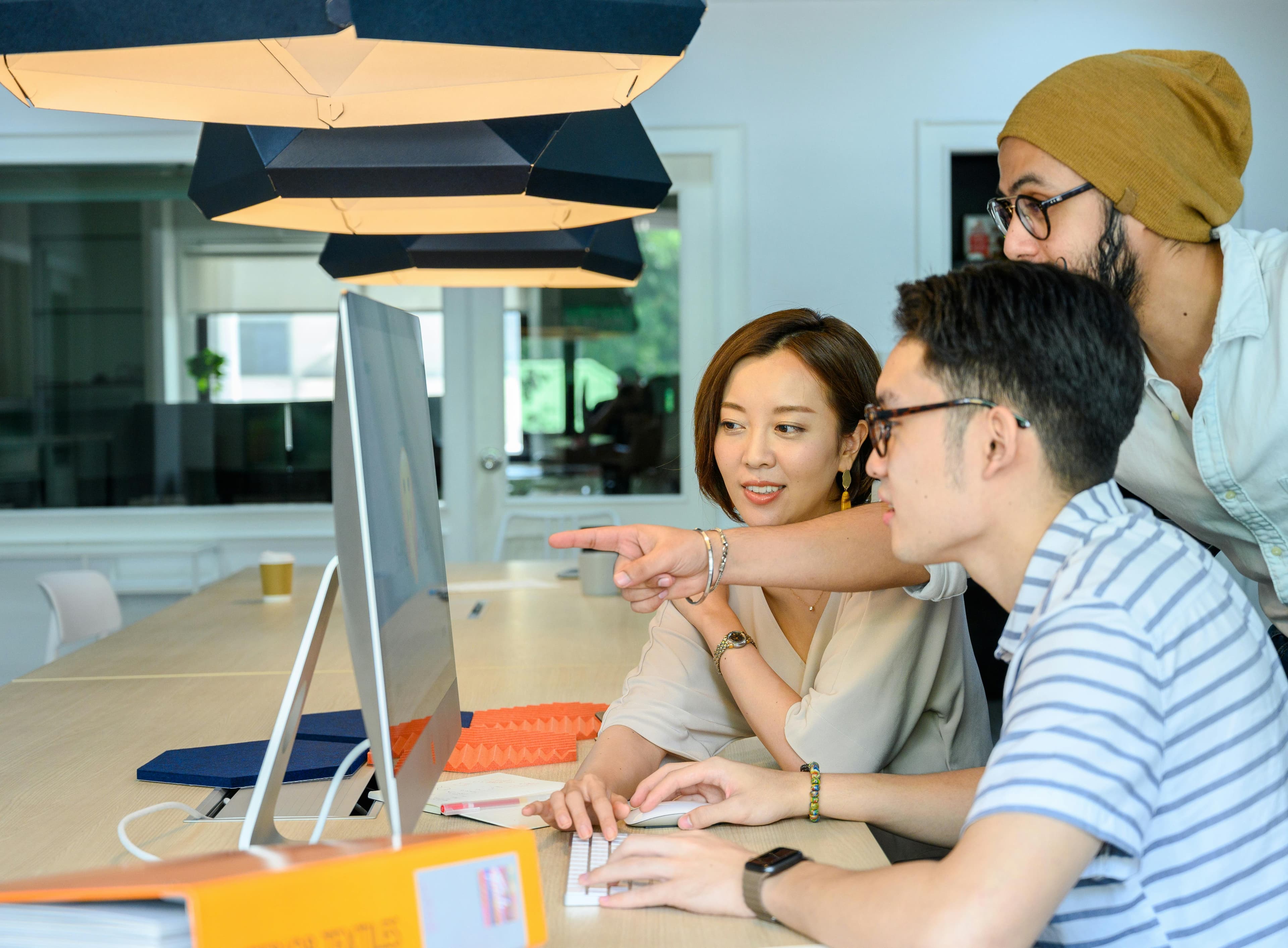 People looking at a computer in office