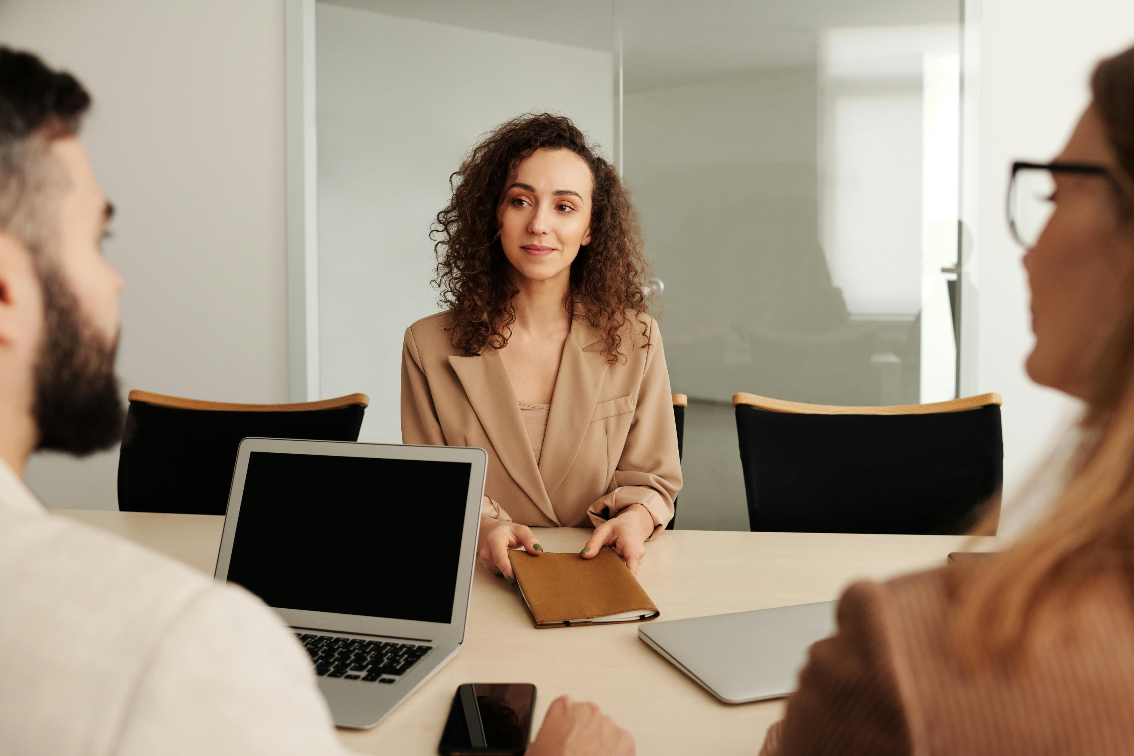 A woman in a business suit participates in a job interview