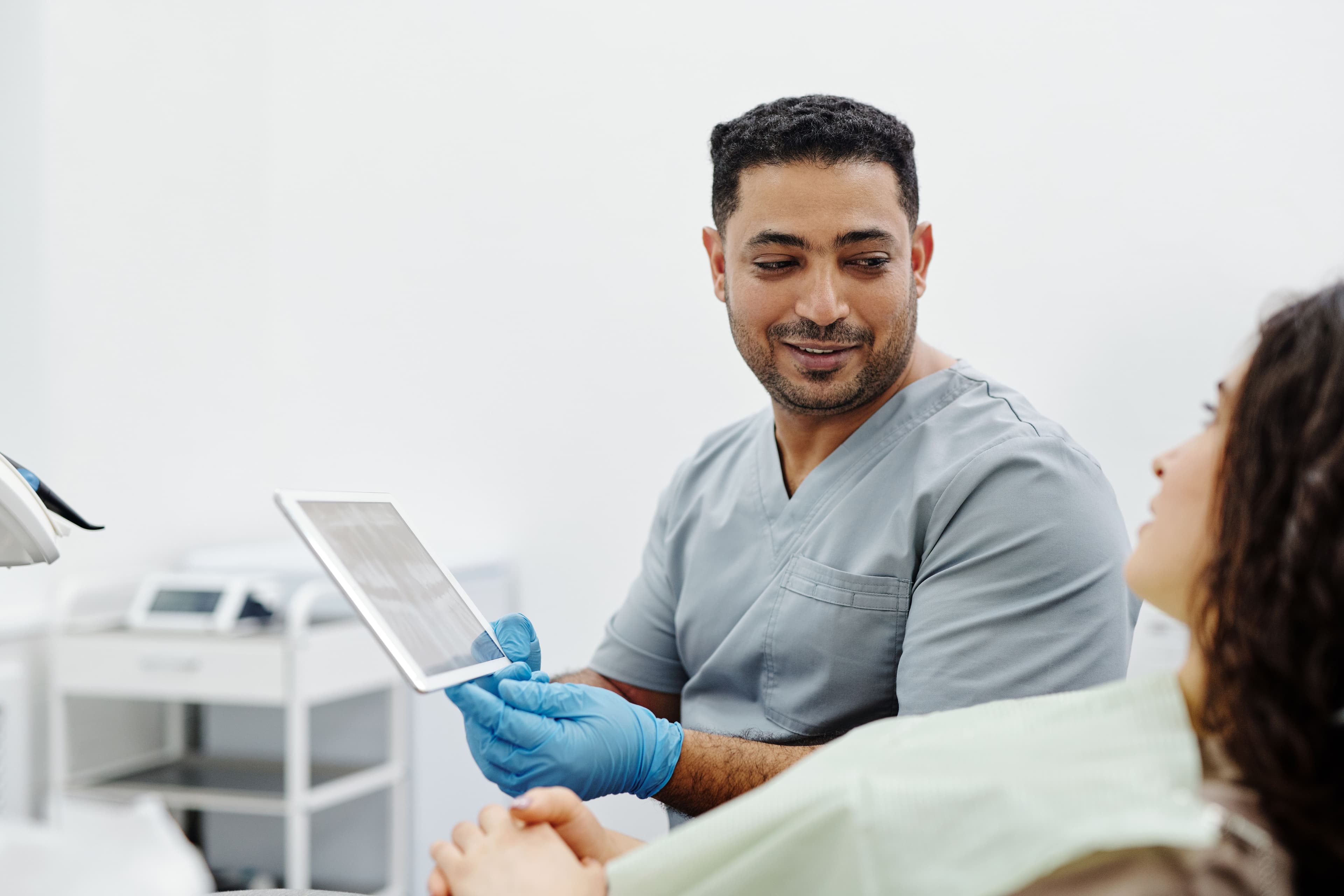 Nurse uses a digital tablet for patient consultation