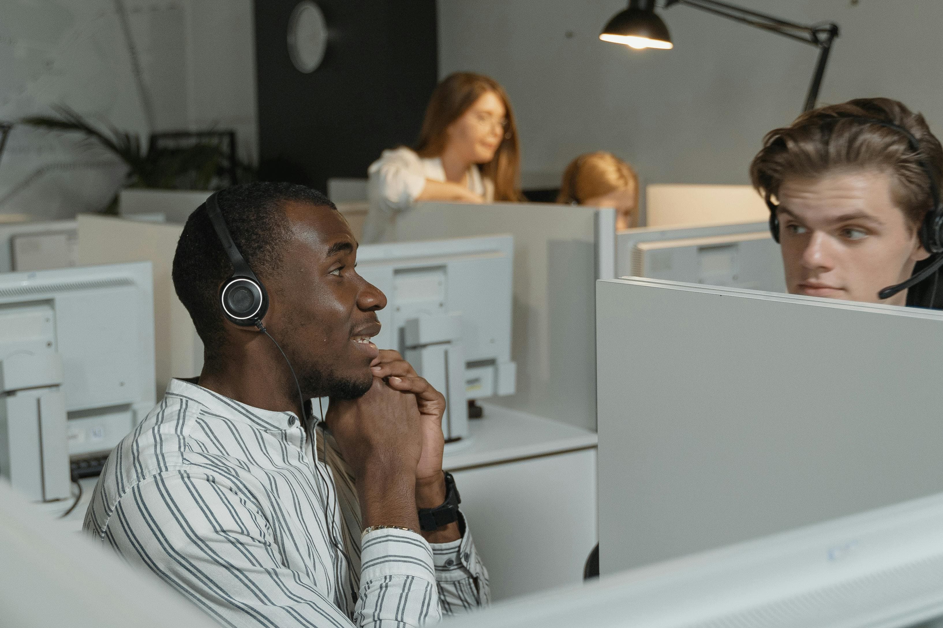 Call center team collaborating with headsets