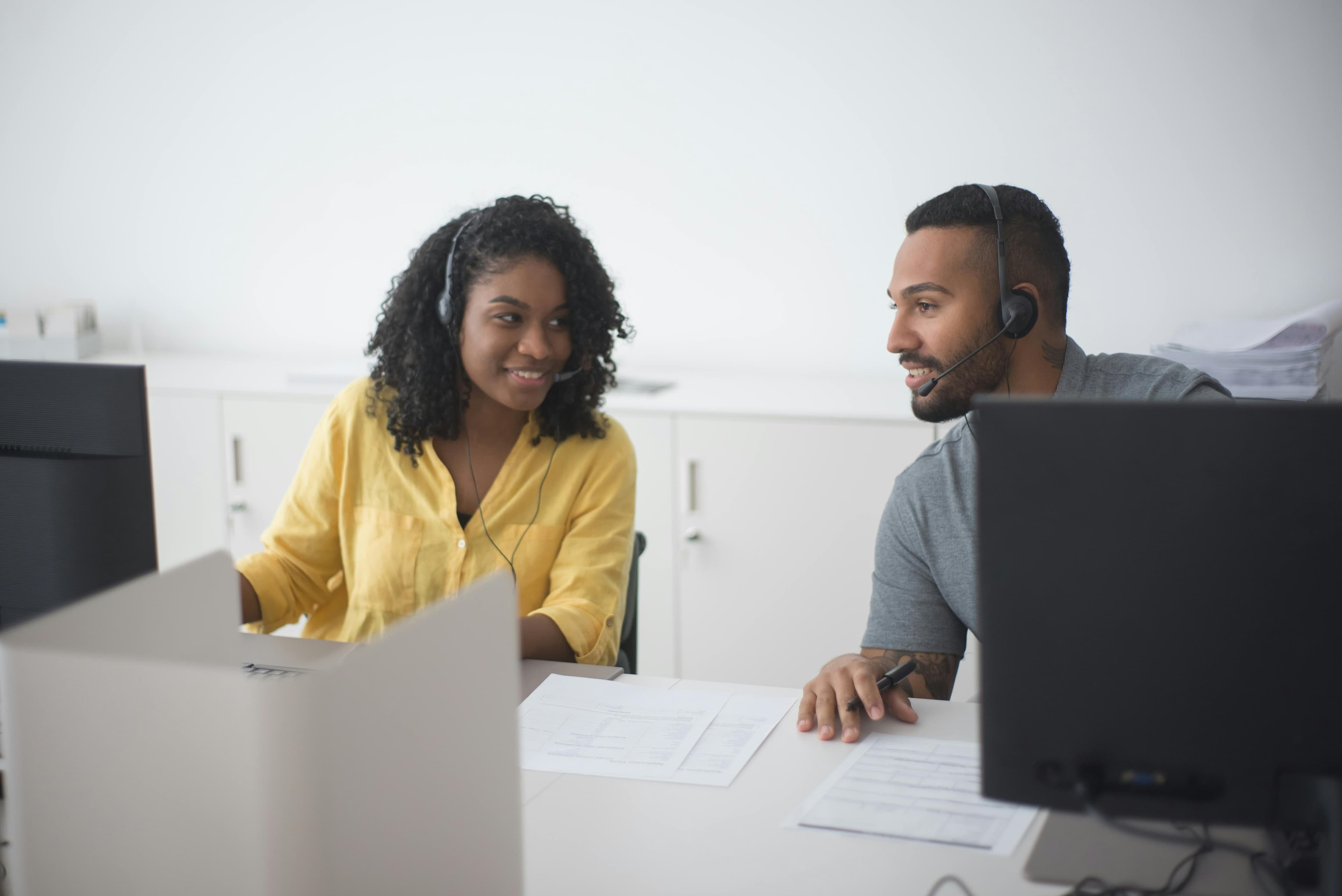 Contact center employees discussing while working