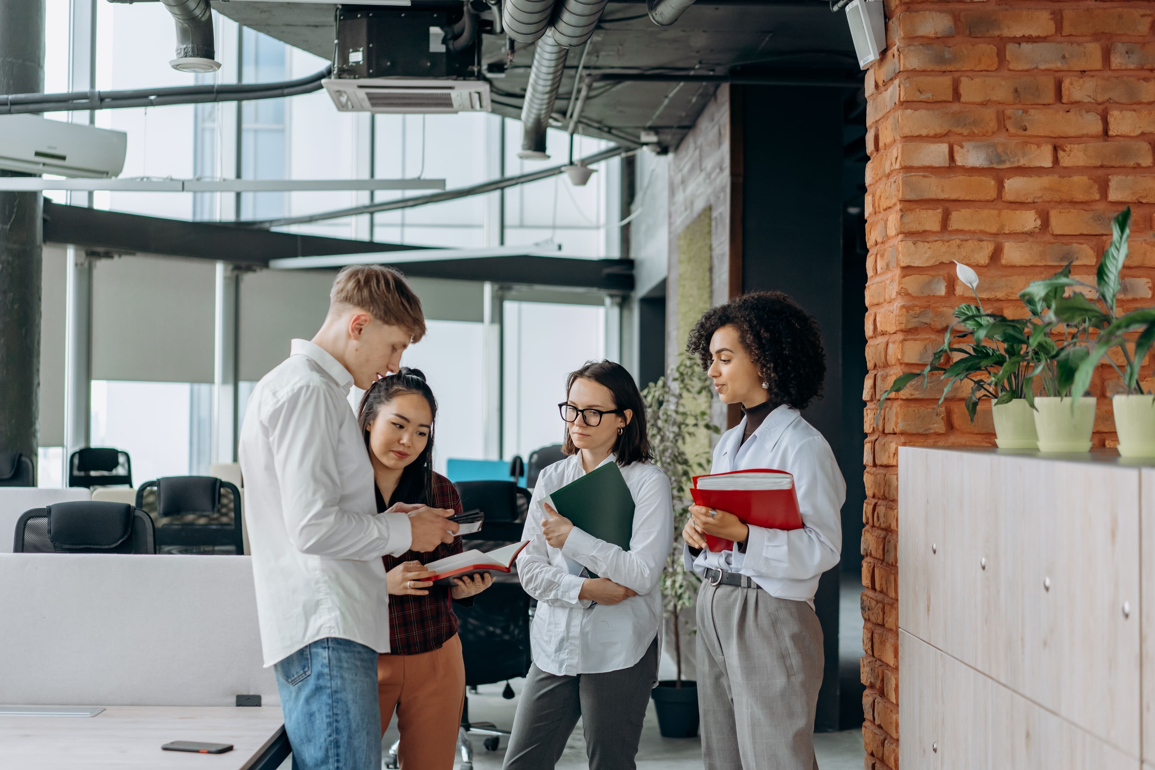 A diverse team of professionals collaborates in a modern office setting